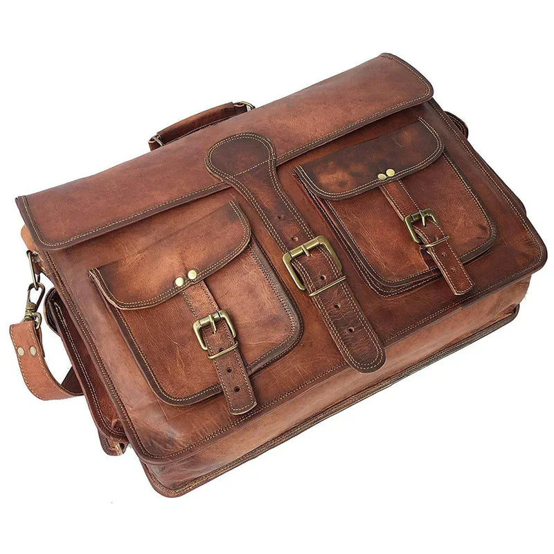 Brown leather satchel bag with brass buckles on a white background